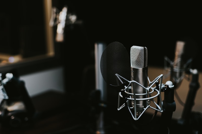 Two microphones on stands inside a radio booth